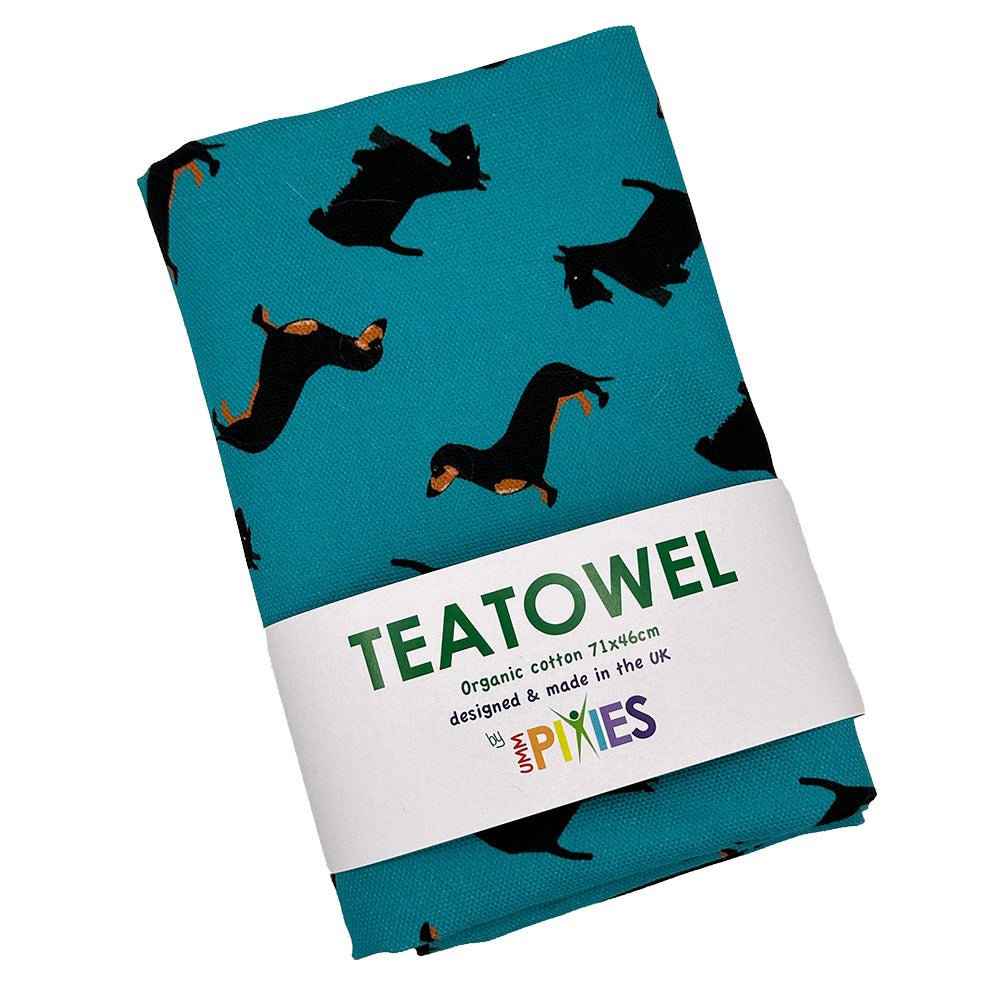 Dogs organic cotton tea towel shown in packaging