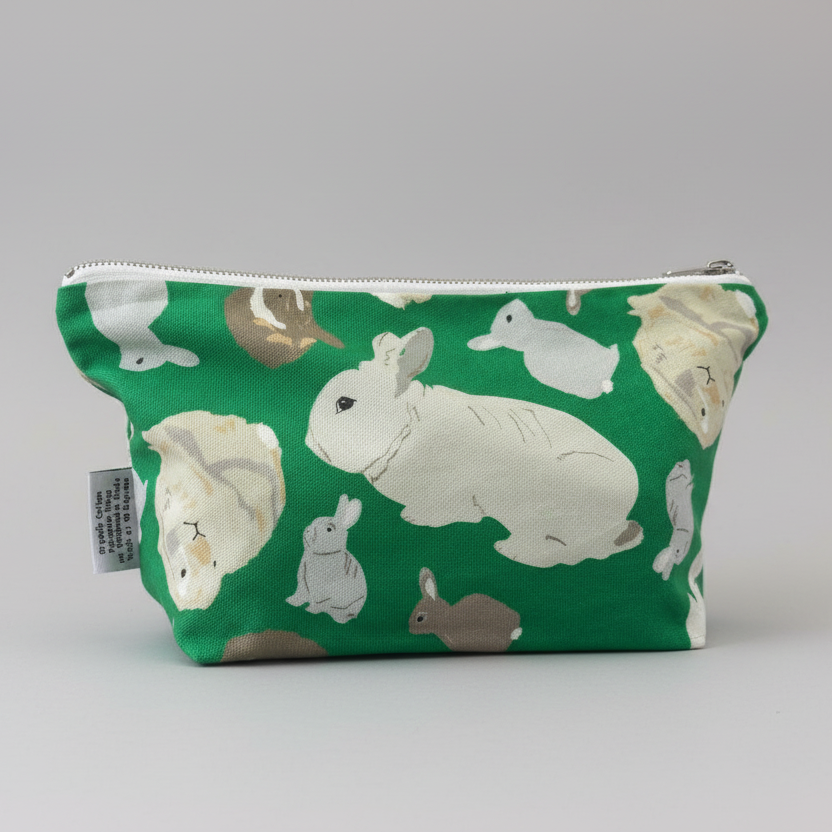 Green, zipped, fabric pouch with rabbits pattern 