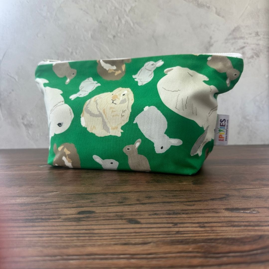 Birght green rabbit zipped bag on a wooden counter