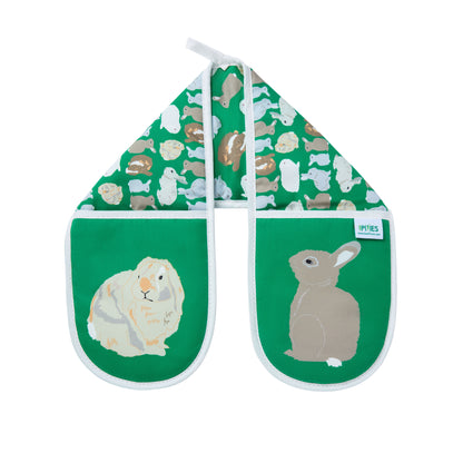 Pair of green organic cotton oven mitts with rabbit illustrations on a white background