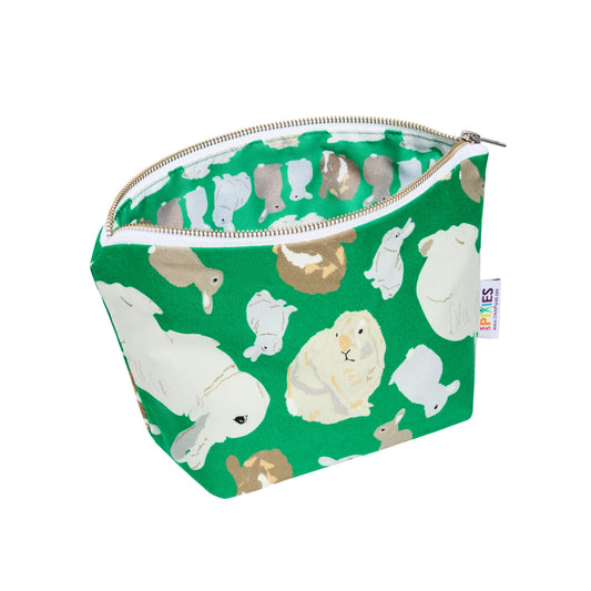 Green zipped pouch with rabbit pattern shown open to reveal printed waterproof lining.