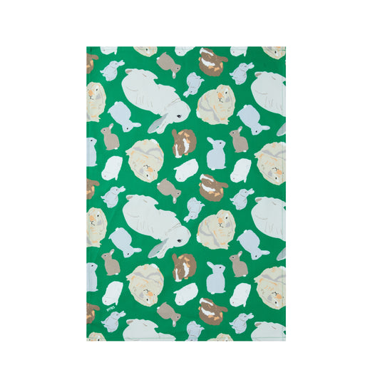 Green cotton kitchen towel with rabbits design shown laying flat on a white background