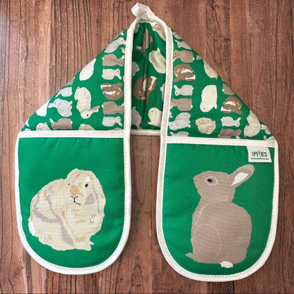 Bright Green Rabbits design organic cotton Oven Mitts on a wooden counter