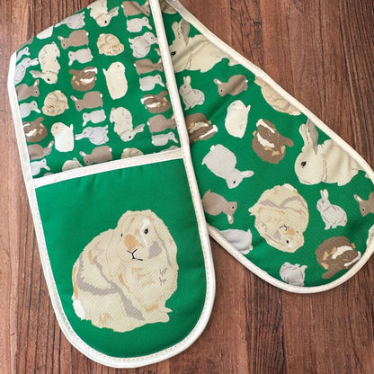 Bright Green Rabbits design organic cotton Oven Mitts shown on a wooden counter