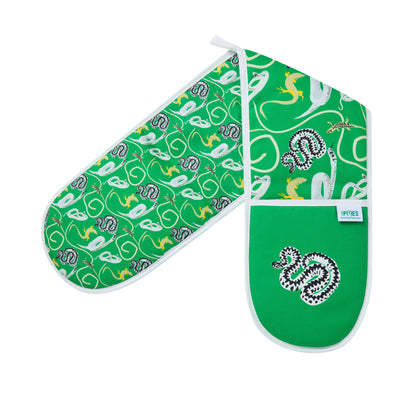 Green oven mitts with snakes and lizards patterns on a wooden surface