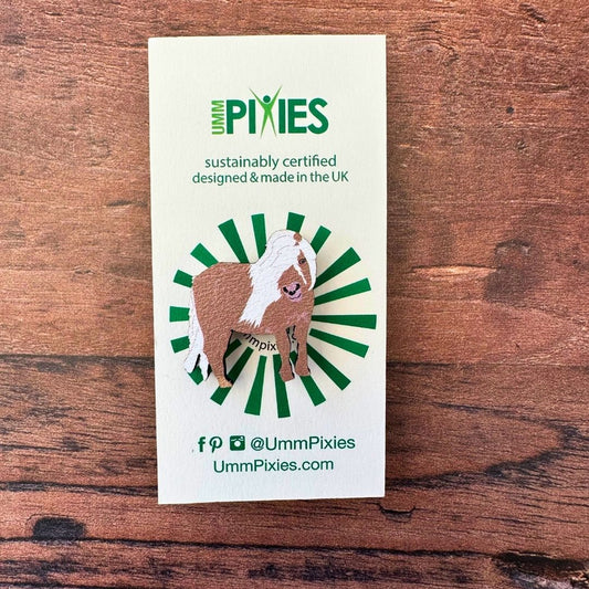 Shetland Pony wooden pin badge on display card on wooden table