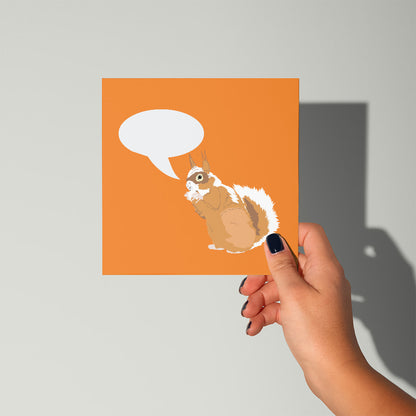Hand holding a card with a squirrel illustration and speech bubble on an orange background