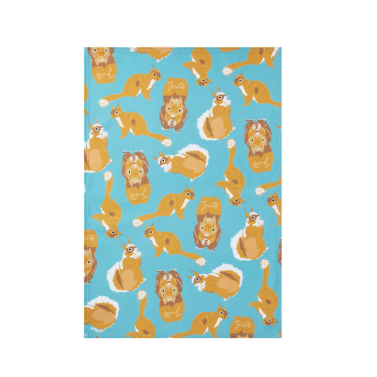 Luxury organic cotton tea towel printed with pattern of squirrels on a blue background