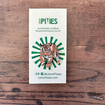Tiger cub wooden pin badge on display card on wooden table