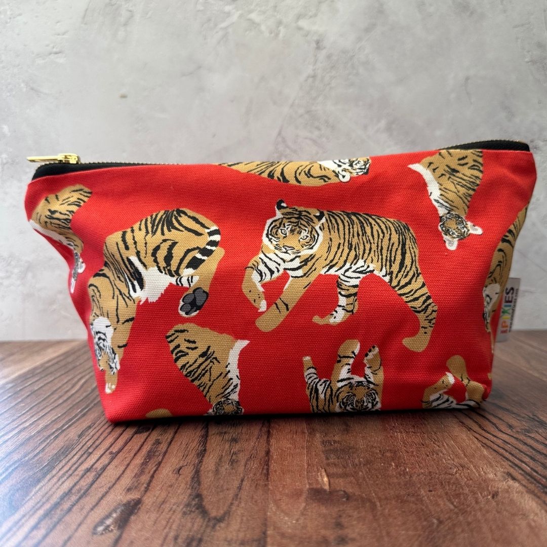 Bright Red Sumatran Tiger illustrations of this  really useful bag shown with zip closed on a wooden counter