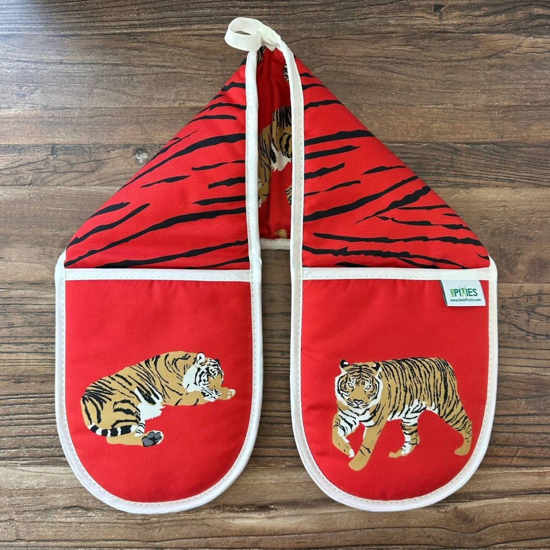  Red Tigers design organic cotton oven gloves on wooden surface