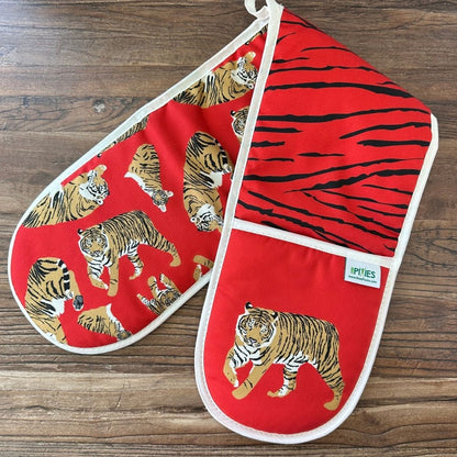Red Tigers design organic cotton oven gloves on wooden surface