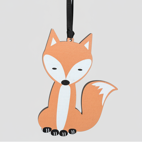 Wooden fox hanging decoration on a plain background