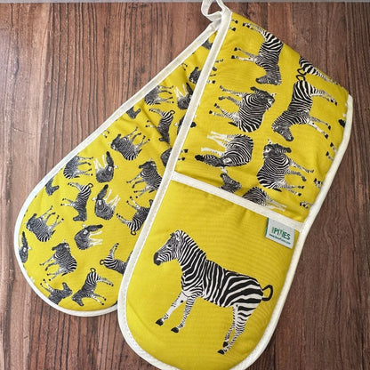 Yellow Zebra illustrated organic cotton oven gloves on wooden surface