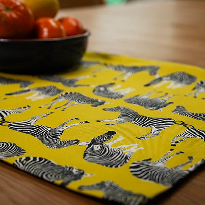Yellow tea towel with zebra pattern on a wooden table