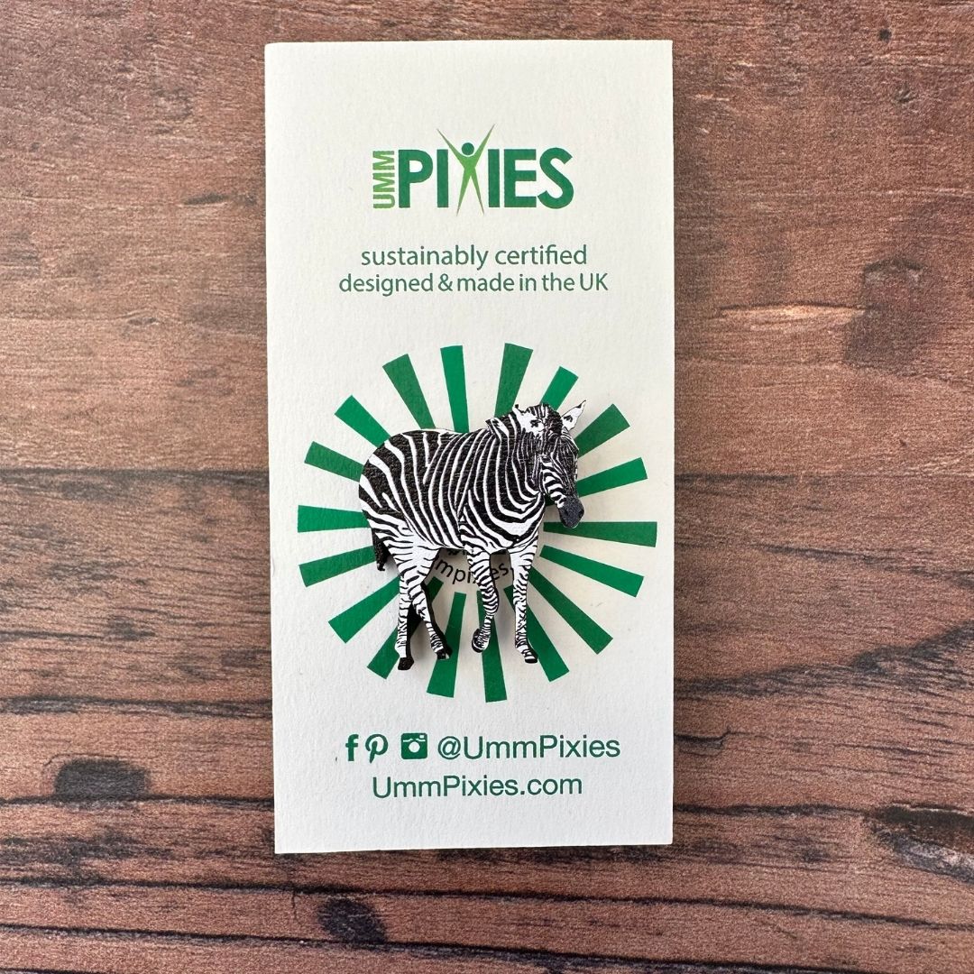 Zebra wooden pin badge on display card on wooden table