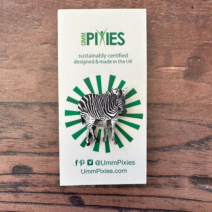 Zebra wooden pin badge on display card on wooden table