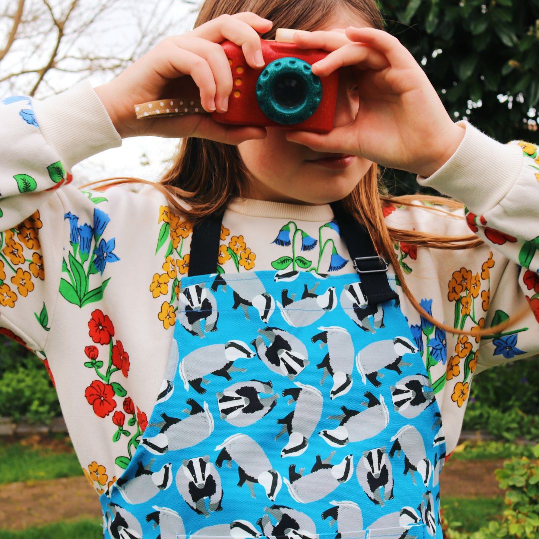 blue badger apron shown worn by older child 6-12 years Photo credit @rachelandthelittlebirds