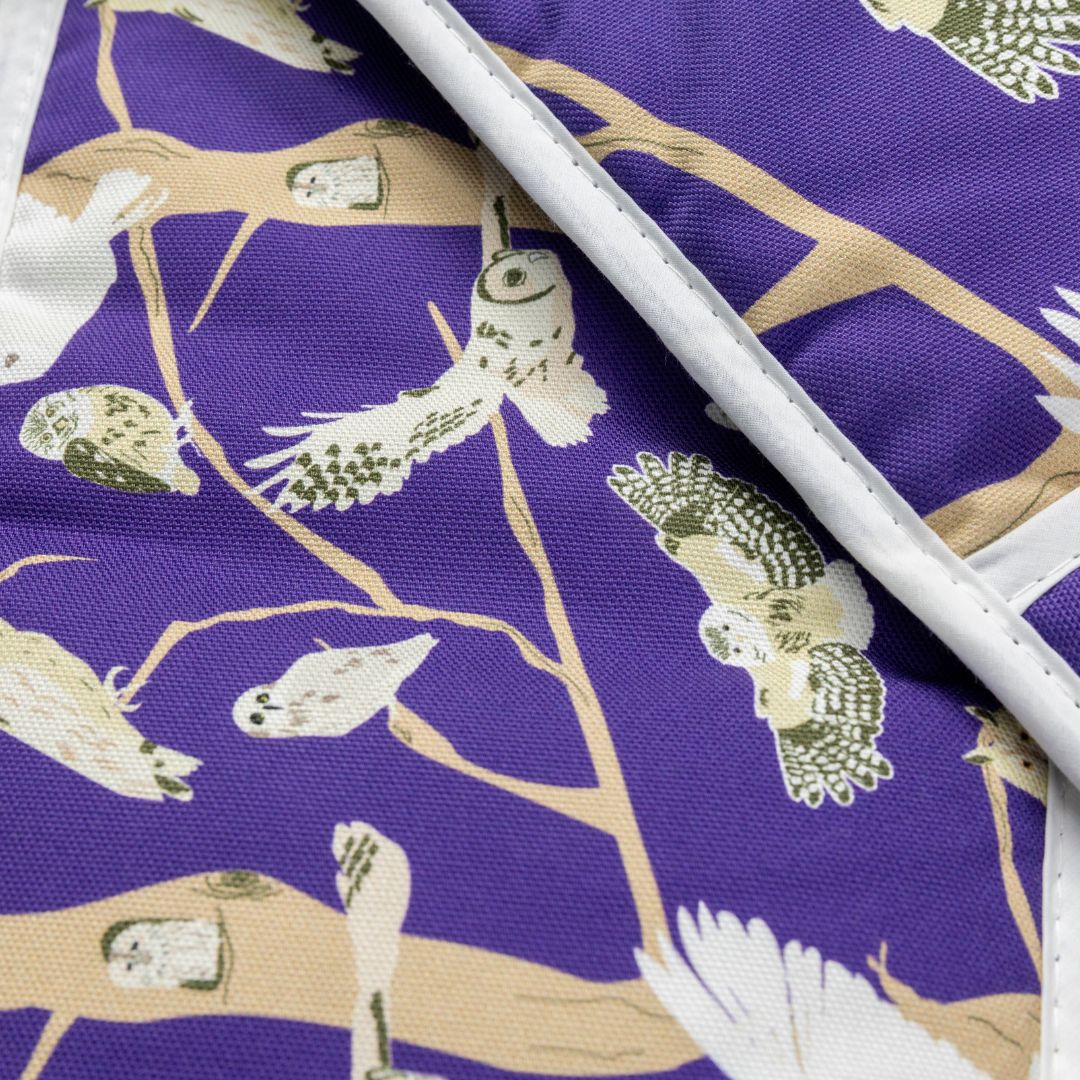 Close up details of the purple oven gloves with pattern featuring the  5 species of native British owl.