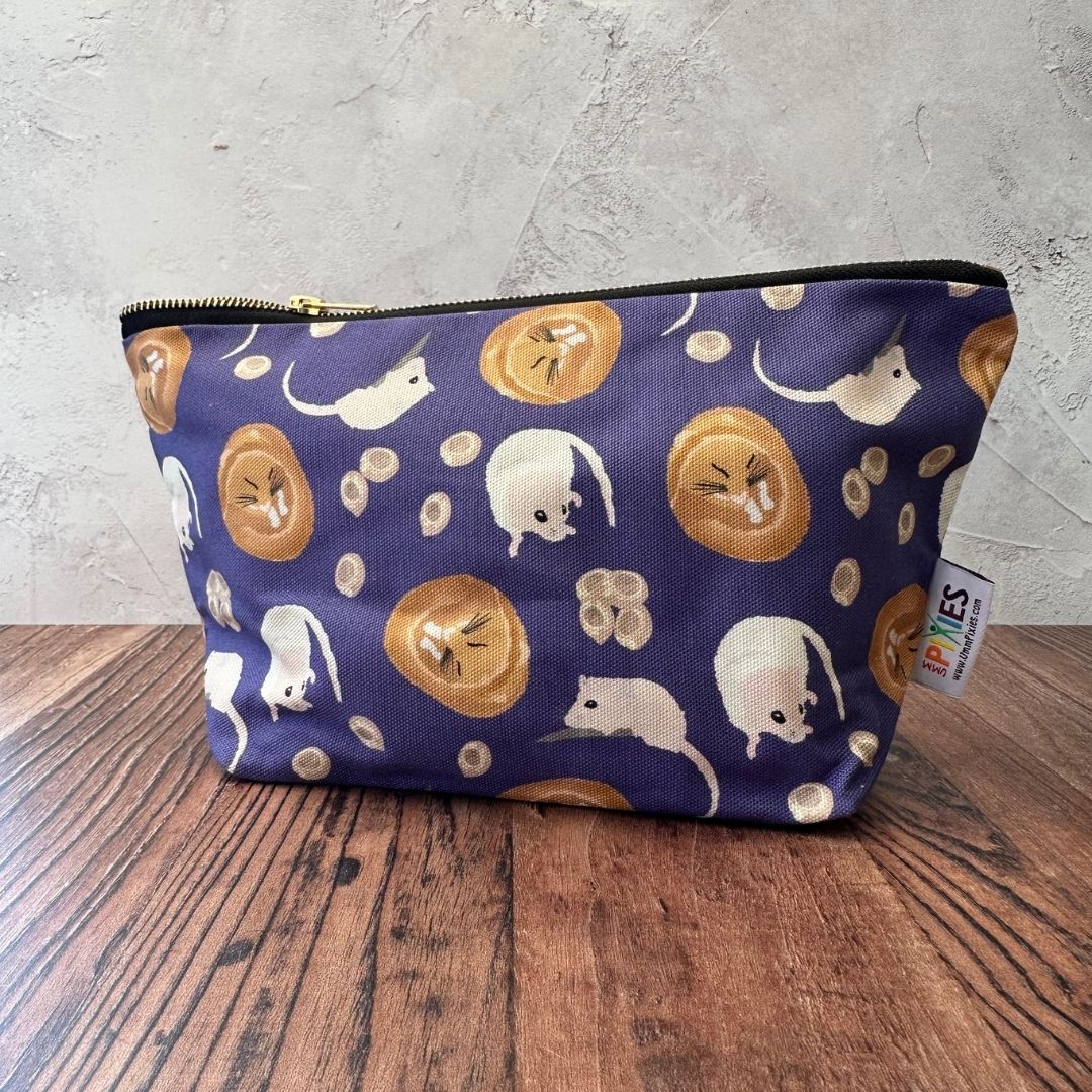 Purple Dormouse illustrated really useful bag shown with zip closed on a wooden countertop