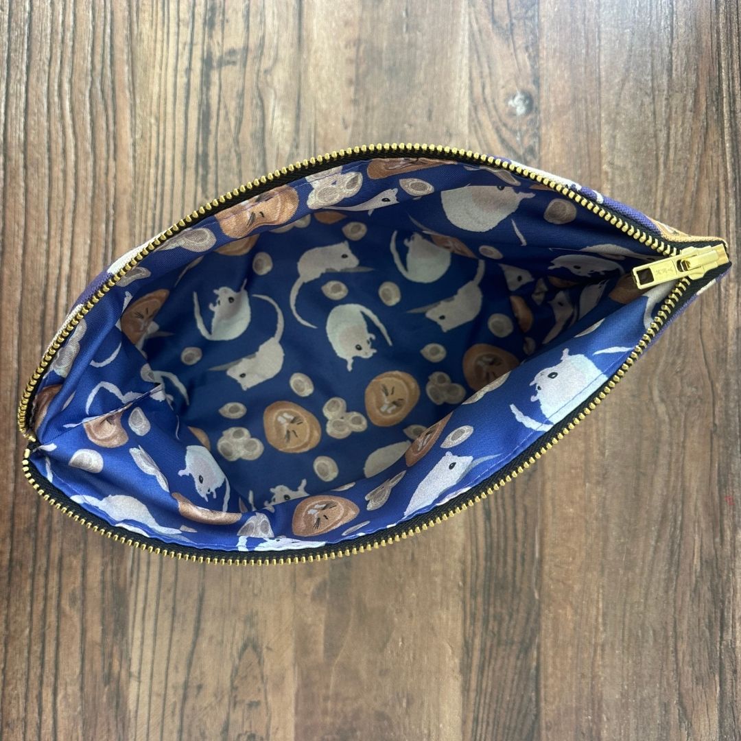 Purple Dormouse illustrated really useful bag shown from above with zip open and waterproof printed lining visible 