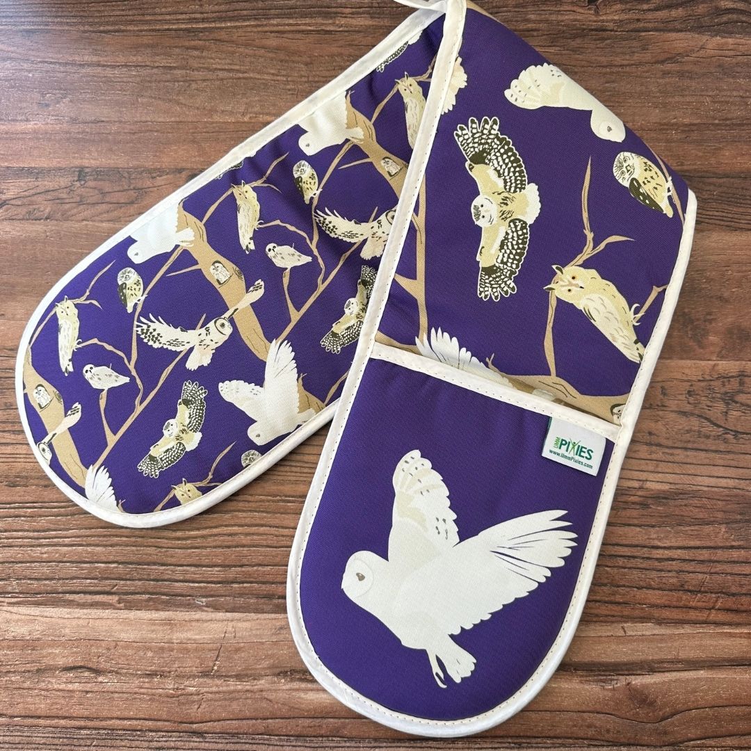 organic cotton owls oven gloves shown open on wooden countertop