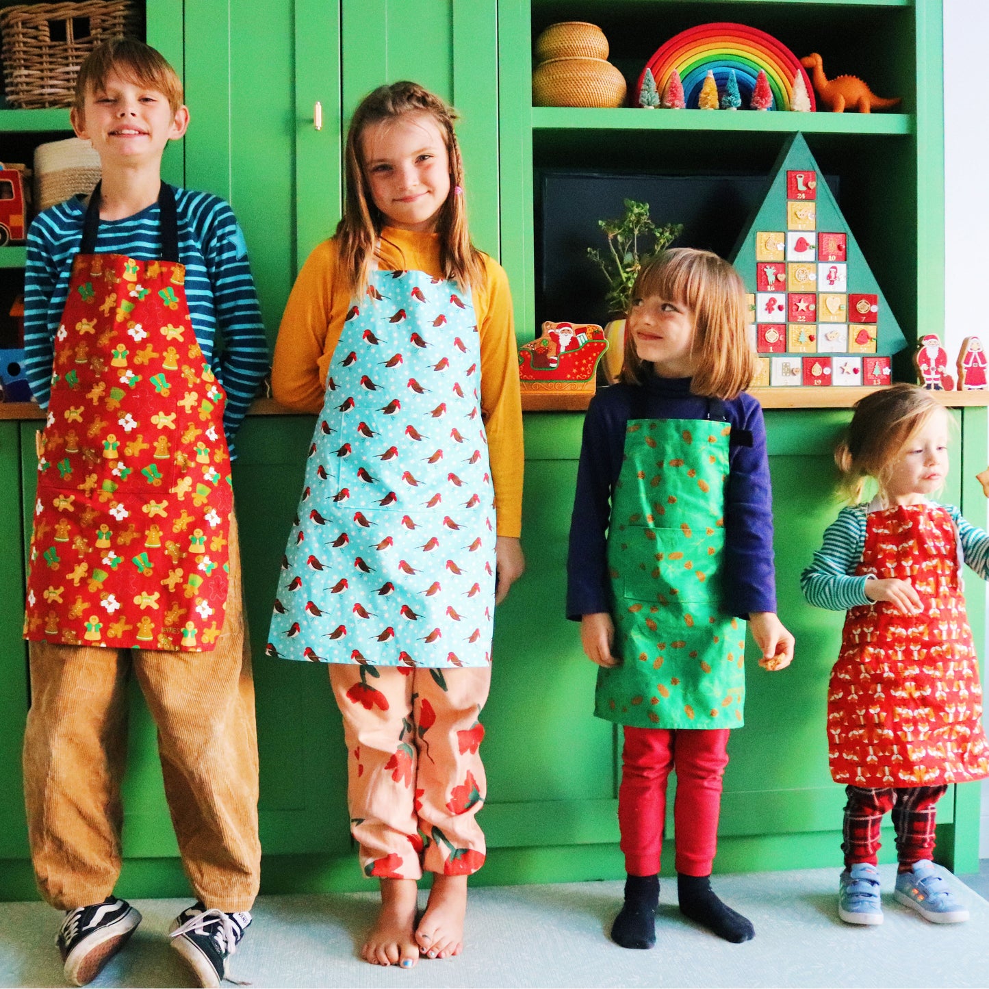 Robins apron, model wears older child size, other models wear other seasonal designs 