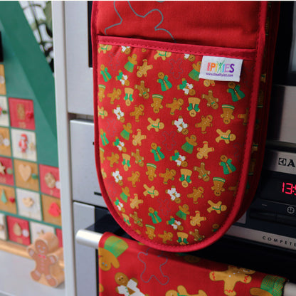Gingerbread Ovengloves shown hanging on an oven door