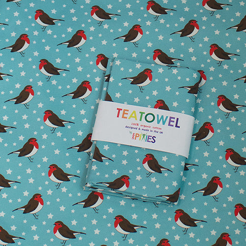 Robins tea towel shown in recyclable packaging laid on  opened tea towel design