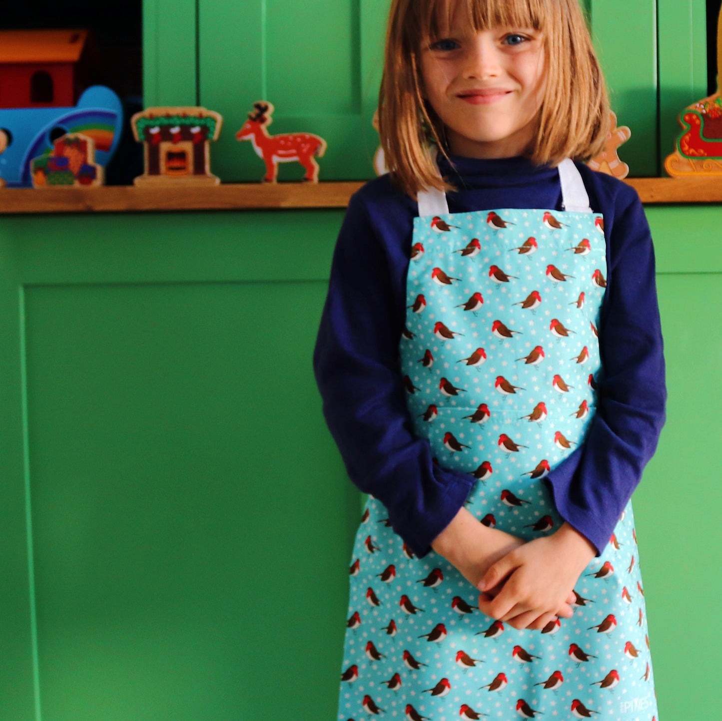 Robins apron, model wears younger child size